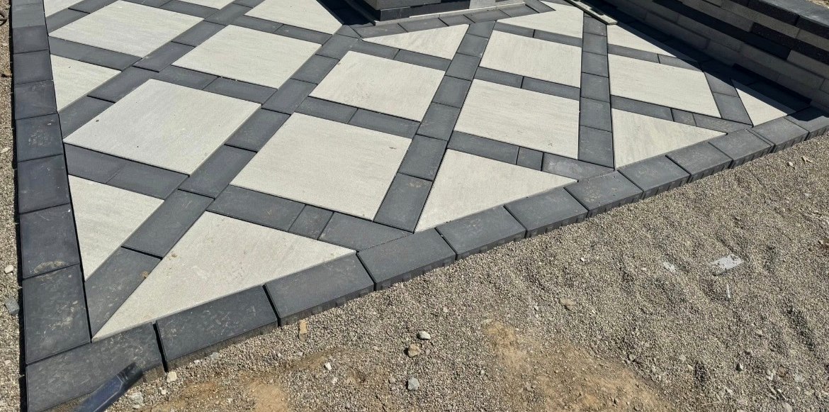Diamond-pattern paver patio with built-in fire pit