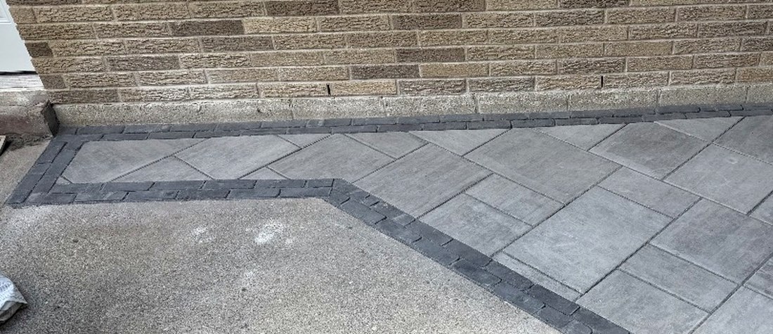 Diamond-set paver patio with charcoal contrast banding