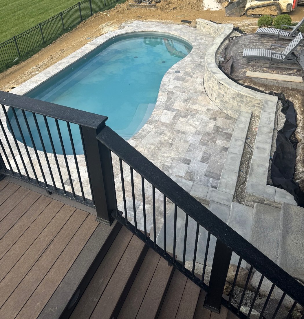Pool deck with stone surround and seat wall